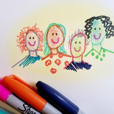 Cartoon drawing of four smiling faces